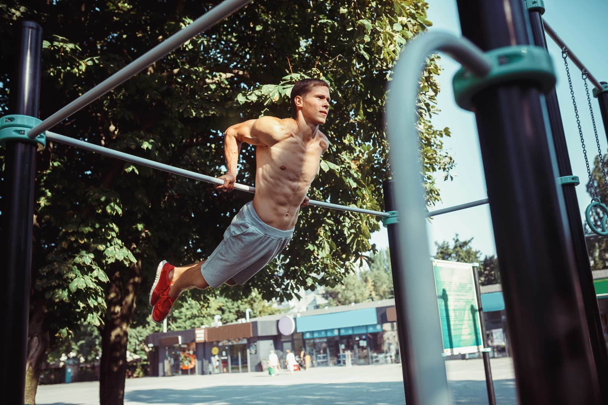 Un sportif s'entrainant au street workout sur une barre fixe